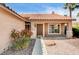 Close-up of a charming front entrance with a well-kept garden and tile roof detail at 8851 Quintane Ln, Las Vegas, NV 89123
