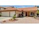 Inviting front yard with desert landscaping leading to a well-maintained home with a tile roof at 8851 Quintane Ln, Las Vegas, NV 89123