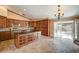 Spacious kitchen features a large island, stainless steel appliances, wood cabinets and door to the backyard at 8851 Quintane Ln, Las Vegas, NV 89123