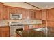 Close up view of kitchen area, shows stainless steel appliances, tile backsplash and granite countertop at 8851 Quintane Ln, Las Vegas, NV 89123