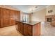 Kitchen island with granite countertops, wooden cabinets, and stainless steel appliances at 8851 Quintane Ln, Las Vegas, NV 89123