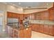 Well-equipped kitchen featuring stainless steel appliances and wooden cabinets at 8851 Quintane Ln, Las Vegas, NV 89123