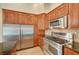 Kitchen with stainless steel appliances, granite countertop and ample wood cabinets at 8851 Quintane Ln, Las Vegas, NV 89123