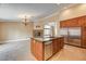 Open kitchen with granite island, stainless steel appliances, and stone fireplace at 8851 Quintane Ln, Las Vegas, NV 89123