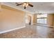 Expansive living room featuring tile floors, decorative ceilings, and large windows for ample light at 8851 Quintane Ln, Las Vegas, NV 89123