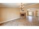 Spacious living room features a stone fireplace and an elegant chandelier at 8851 Quintane Ln, Las Vegas, NV 89123