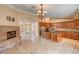 Open concept living room features a stone fireplace and leads into a kitchen with granite countertops at 8851 Quintane Ln, Las Vegas, NV 89123