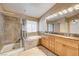 This bathroom features a tub, stand up shower, and double sink vanity with granite countertop at 8851 Quintane Ln, Las Vegas, NV 89123