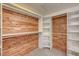 This walk-in closet features custom wood paneling, shelves, and rack systems for ample storage at 8851 Quintane Ln, Las Vegas, NV 89123