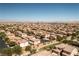 Expansive aerial view of a residential neighborhood with terra-cotta rooftops and the city skyline in the distance at 8853 Autumn Teal Ave, Las Vegas, NV 89178