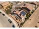 Aerial view of a modern home with solar panels, a well-maintained yard, and neighborhood street at 8853 Autumn Teal Ave, Las Vegas, NV 89178