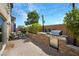 Backyard patio featuring a gas grill, stone accents, dining area, and lush landscaping at 8853 Autumn Teal Ave, Las Vegas, NV 89178