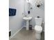 Well-lit half bathroom featuring modern fixtures, a pedestal sink, and contemporary decor at 8853 Autumn Teal Ave, Las Vegas, NV 89178