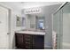 This bathroom features a granite countertop with dual sinks and a glass-enclosed shower at 8853 Autumn Teal Ave, Las Vegas, NV 89178