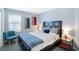 This bedroom has a dark-wood bed frame and vibrant artwork on the walls at 8853 Autumn Teal Ave, Las Vegas, NV 89178