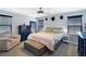 A spacious bedroom with a ceiling fan, a bed with a bench at the end, and two bedside tables at 8853 Autumn Teal Ave, Las Vegas, NV 89178