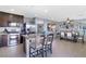 Stylish kitchen featuring stainless steel appliances, dark cabinets, a center island, and an open concept at 8853 Autumn Teal Ave, Las Vegas, NV 89178