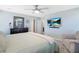 This main bedroom has a ceiling fan, TV, and decorative mirror above a bureau at 8853 Autumn Teal Ave, Las Vegas, NV 89178