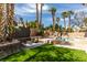 Resort-style pool with lush landscaping, rock features, and shaded seating area is perfect for outdoor living at 8913 Saint Pierre Dr, Las Vegas, NV 89134