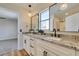 Modern bathroom with dual sinks, granite countertop, and decorative hanging lights at 8913 Saint Pierre Dr, Las Vegas, NV 89134