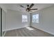 An empty bedroom features carpeted floors, natural light, and a ceiling fan at 8913 Saint Pierre Dr, Las Vegas, NV 89134