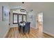 Bright dining room with hardwood floors and chandelier, adjacent to a modern living area at 8913 Saint Pierre Dr, Las Vegas, NV 89134