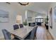 Bright dining room with hardwood floors, chandelier, adjacent to a modern living area at 8913 Saint Pierre Dr, Las Vegas, NV 89134