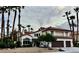 Exterior view of a two-story home with a red tile roof and tall palm trees at 8913 Saint Pierre Dr, Las Vegas, NV 89134