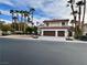 Street view of a two-story home with a two-car garage and mature landscaping at 8913 Saint Pierre Dr, Las Vegas, NV 89134