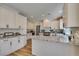 Bright kitchen with granite counters, stainless appliances, and white cabinets at 8913 Saint Pierre Dr, Las Vegas, NV 89134