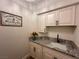 Functional laundry room with granite countertops, sink, and ample cabinet space at 8913 Saint Pierre Dr, Las Vegas, NV 89134