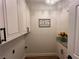 Charming laundry room with white cabinets and granite countertops at 8913 Saint Pierre Dr, Las Vegas, NV 89134