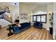 Cozy living room with hardwood floors, high ceilings, staircase and comfortable blue sofa at 8913 Saint Pierre Dr, Las Vegas, NV 89134