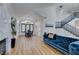 Bright living room with hardwood floors, a view to the dining area, high ceilings and a comfortable blue sofa at 8913 Saint Pierre Dr, Las Vegas, NV 89134