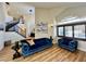 Inviting living room with hardwood floors, high ceilings, staircase and comfortable blue sofa at 8913 Saint Pierre Dr, Las Vegas, NV 89134
