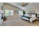 Spacious main bedroom features a fireplace, neutral carpet, ceiling fan and well-lit windows at 8913 Saint Pierre Dr, Las Vegas, NV 89134