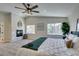 Spacious main bedroom features a fireplace, neutral carpet, ceiling fan and well-lit windows at 8913 Saint Pierre Dr, Las Vegas, NV 89134