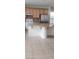 Kitchen with light wood cabinets, a stainless steel refrigerator and a kitchen island at 9162 Weeping Hollow Ave, Las Vegas, NV 89178