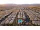 Expansive aerial view of a well-planned community with a pool, landscaping, and mountain views at 9494 Alma Ridge Ave, Las Vegas, NV 89178