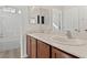 Bathroom featuring double sinks with modern fixtures, a tub, and a shower at 9494 Alma Ridge Ave, Las Vegas, NV 89178