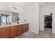 Bathroom featuring double vanity, modern lighting, and wood-look floors at 9494 Alma Ridge Ave, Las Vegas, NV 89178