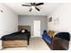 The bedroom has neutral carpet and a ceiling fan for comfort, featuring a rustic bed frame and a futon at 9494 Alma Ridge Ave, Las Vegas, NV 89178