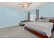 This bedroom features a ceiling fan, large windows, and neutral paint at 9494 Alma Ridge Ave, Las Vegas, NV 89178