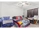This bedroom features a ceiling fan, and large windows for natural light at 9494 Alma Ridge Ave, Las Vegas, NV 89178