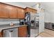 Well-lit kitchen features stainless steel appliances, granite countertops, and dark wood cabinets at 9494 Alma Ridge Ave, Las Vegas, NV 89178