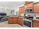 Open kitchen featuring modern appliances, granite countertops, and seamless flow into the living area at 9494 Alma Ridge Ave, Las Vegas, NV 89178