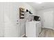 Bright laundry room offers a modern washer and dryer, and convenient storage at 9494 Alma Ridge Ave, Las Vegas, NV 89178