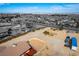 Aerial view of a home and a generous lot under a bright sky; a semi-truck is parked beside a fenced area at 9865 Penny Ln, Las Vegas, NV 89178