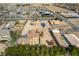 Aerial shot shows a home with desert landscaping surrounded by lush green trees at 9865 Penny Ln, Las Vegas, NV 89178