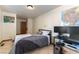 This bedroom features tile flooring, a queen bed, and a computer desk setup at 9865 Penny Ln, Las Vegas, NV 89178